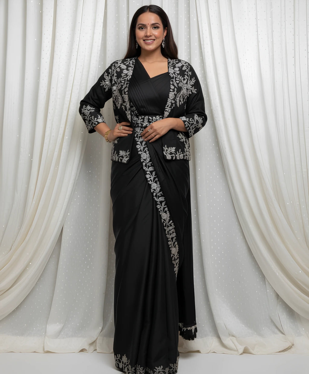 Woman wearing a Fulari black party wear saree with white embroidery jacket 