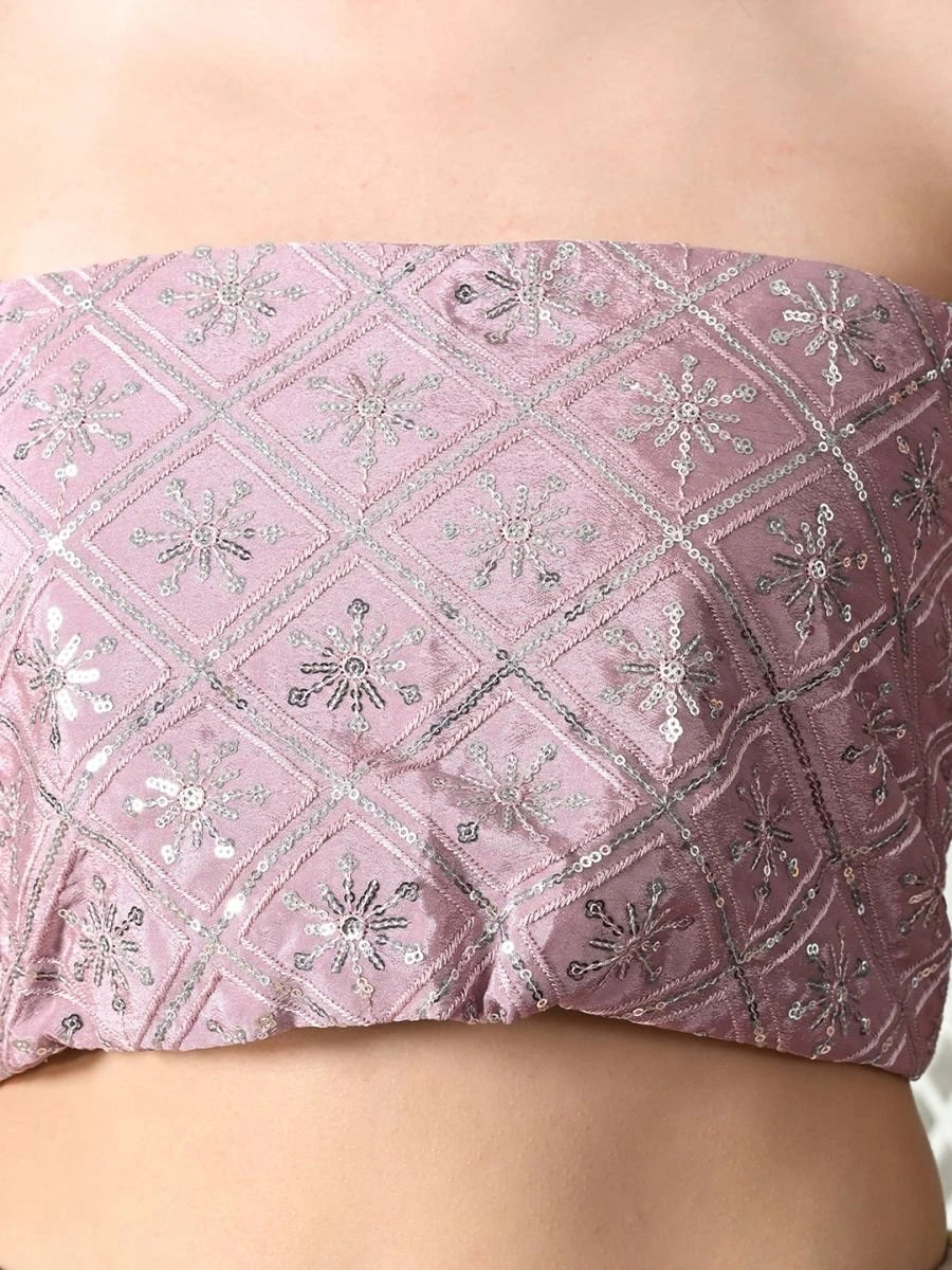 Pink bandeau top with silver floral patterns on a plain background