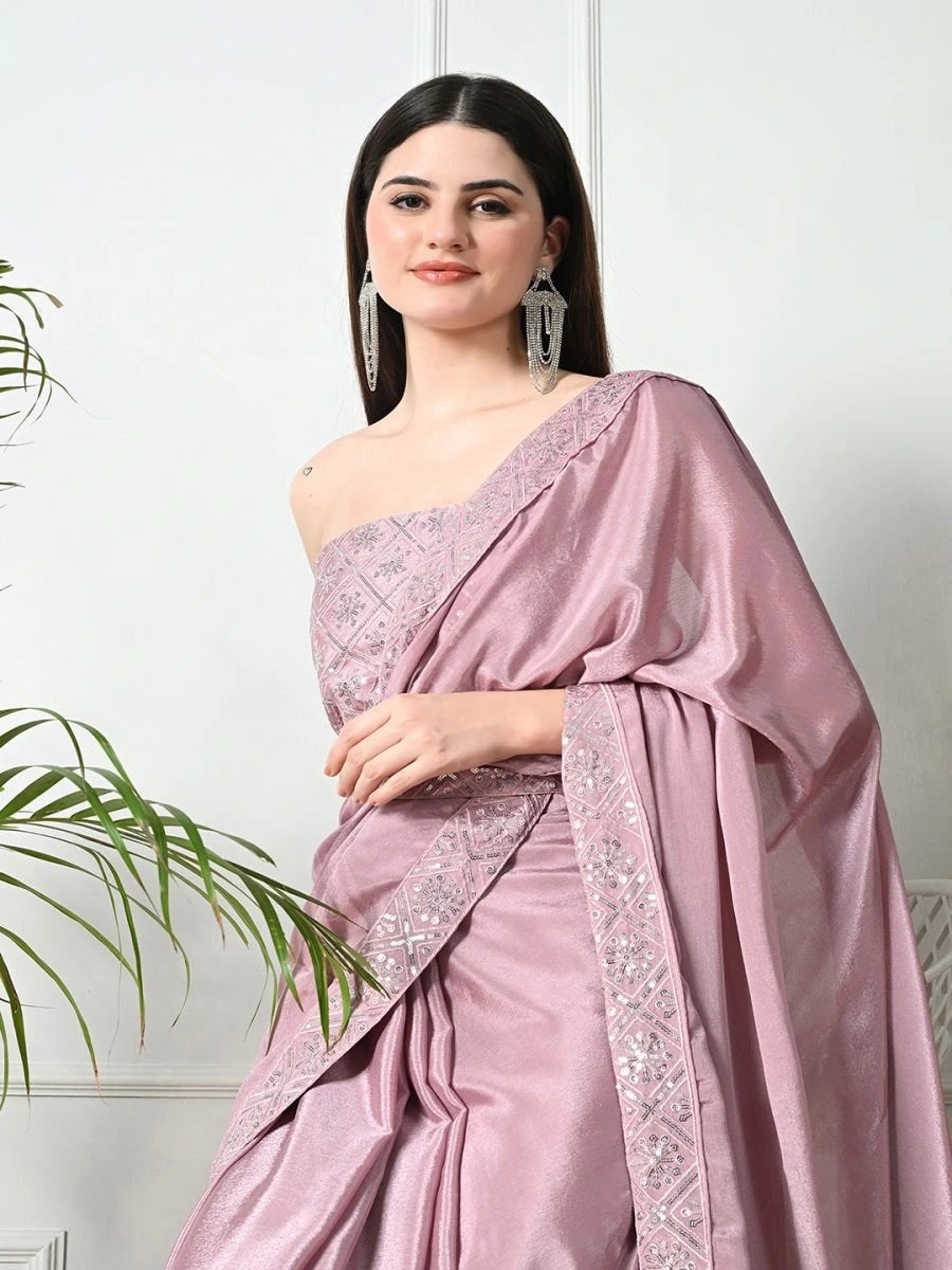 Woman wearing a pink saree with a white background