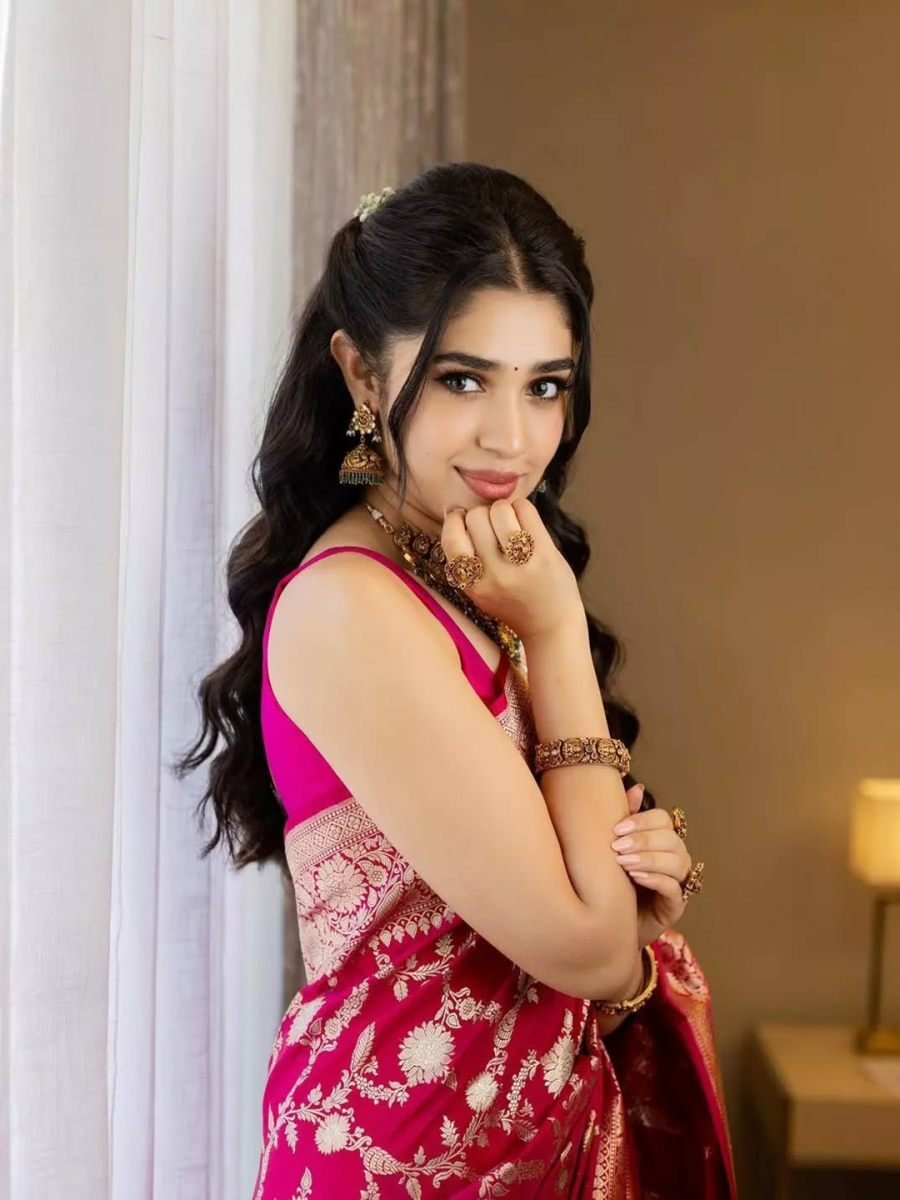 Woman in a pink saree with floral patterns