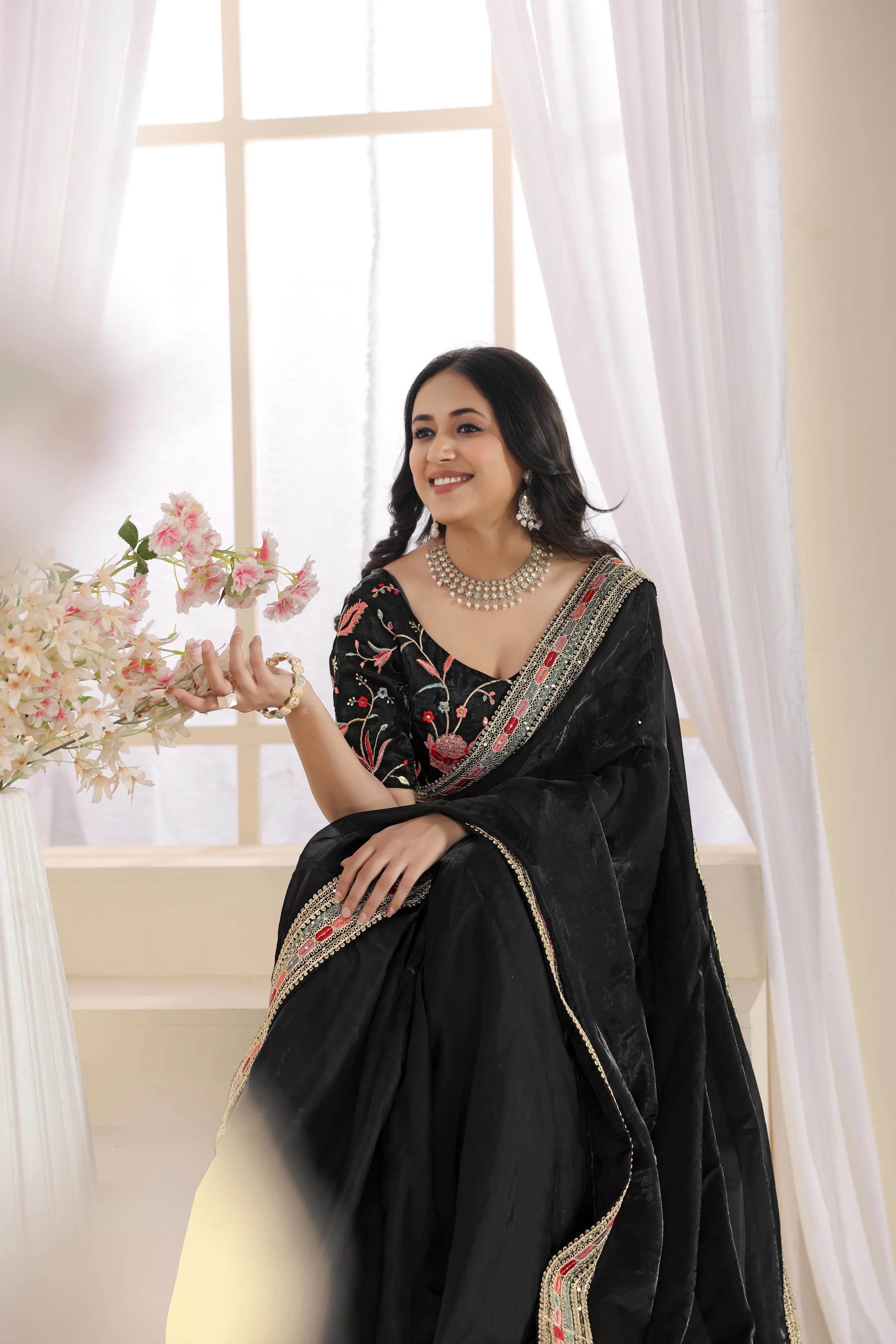 Classic black saree by Fulari with elegant embroidered detailing, designed for sophisticated party wear