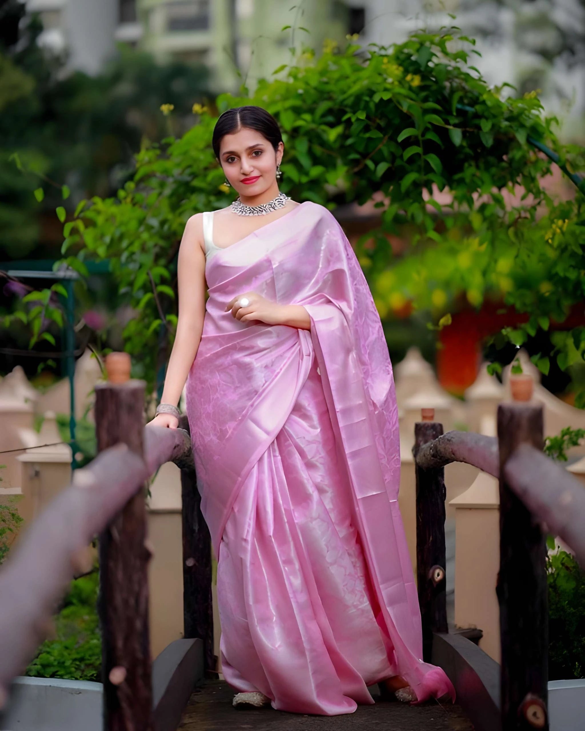 Elegant blush pink saree by Fulari featuring a smooth satin finish, perfect for daytime celebrations and events