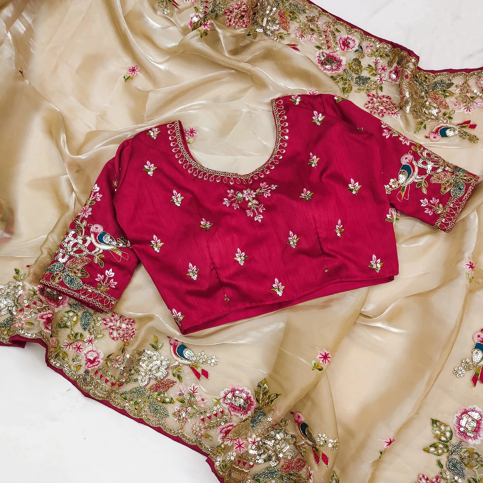 Fulari classic golden organza saree featuring a red embroidered blouse.