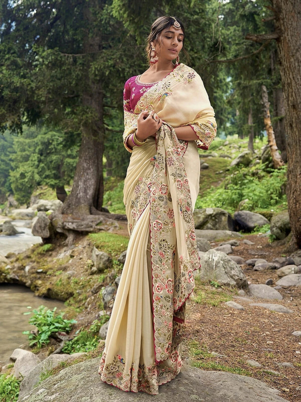 Fulari cream embroidered wedding saree with floral and bird work styled in an outdoor forest photoshoot for festive and shadi wear.