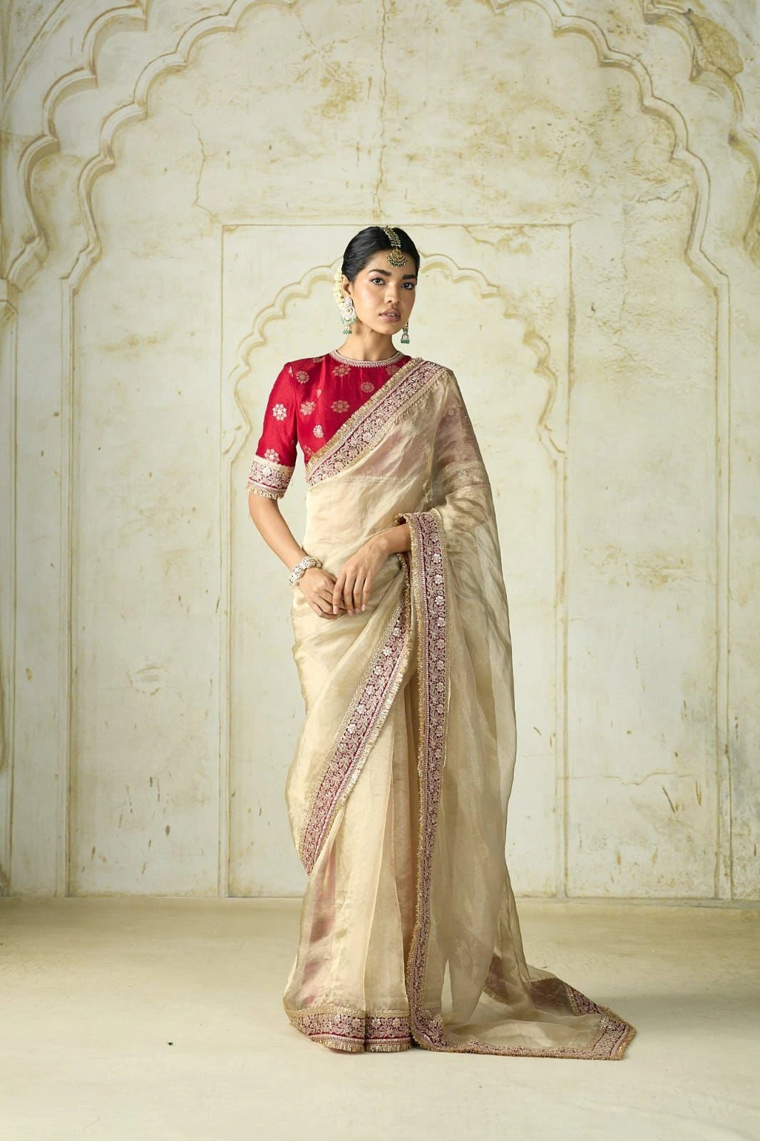 Fulari cream golden saree with embroidered border and red blouse.