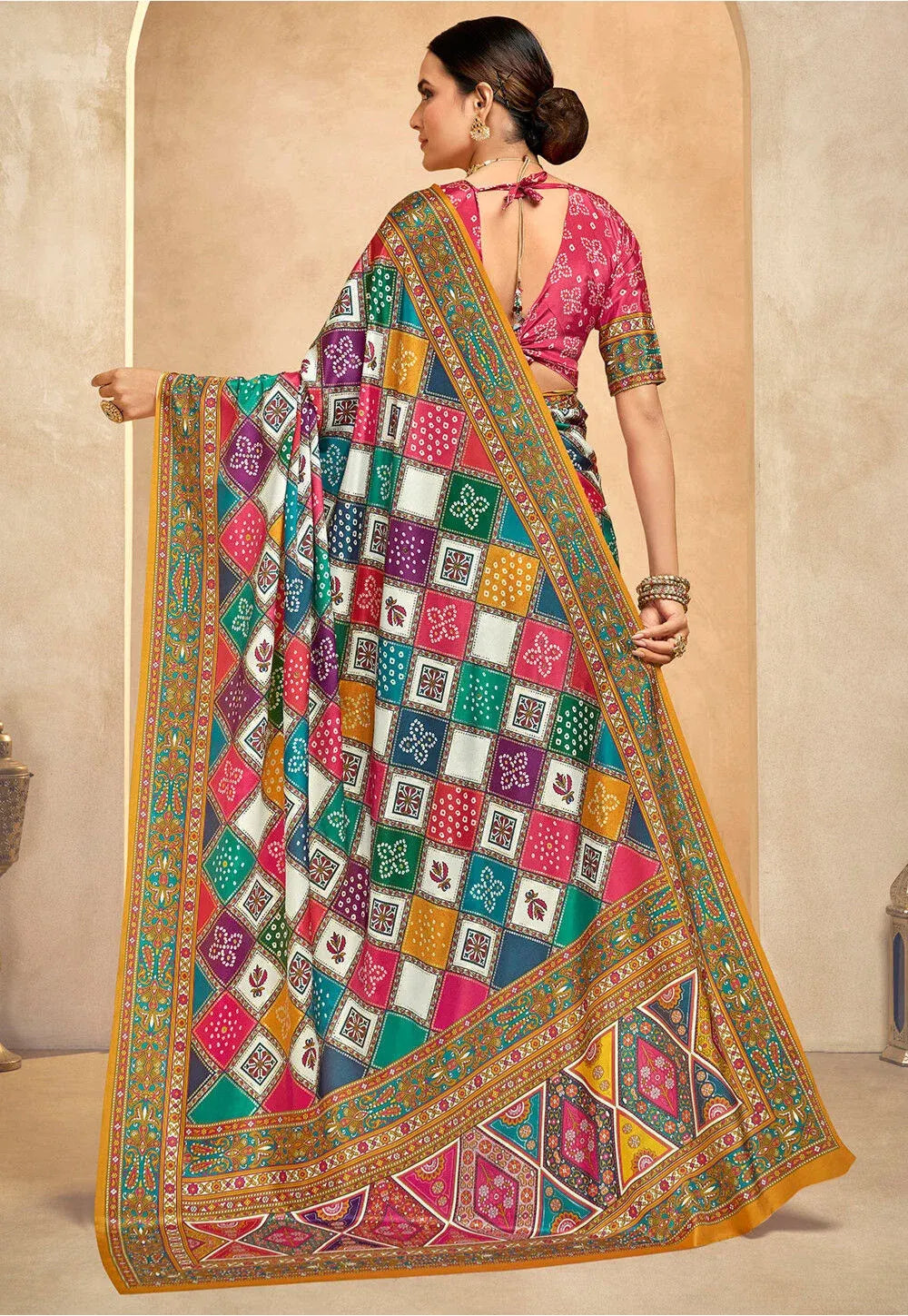 Premium Fulari designer saree in multicolor crepe, paired with a matching pink embroidered blouse and traditional gold jewelry.