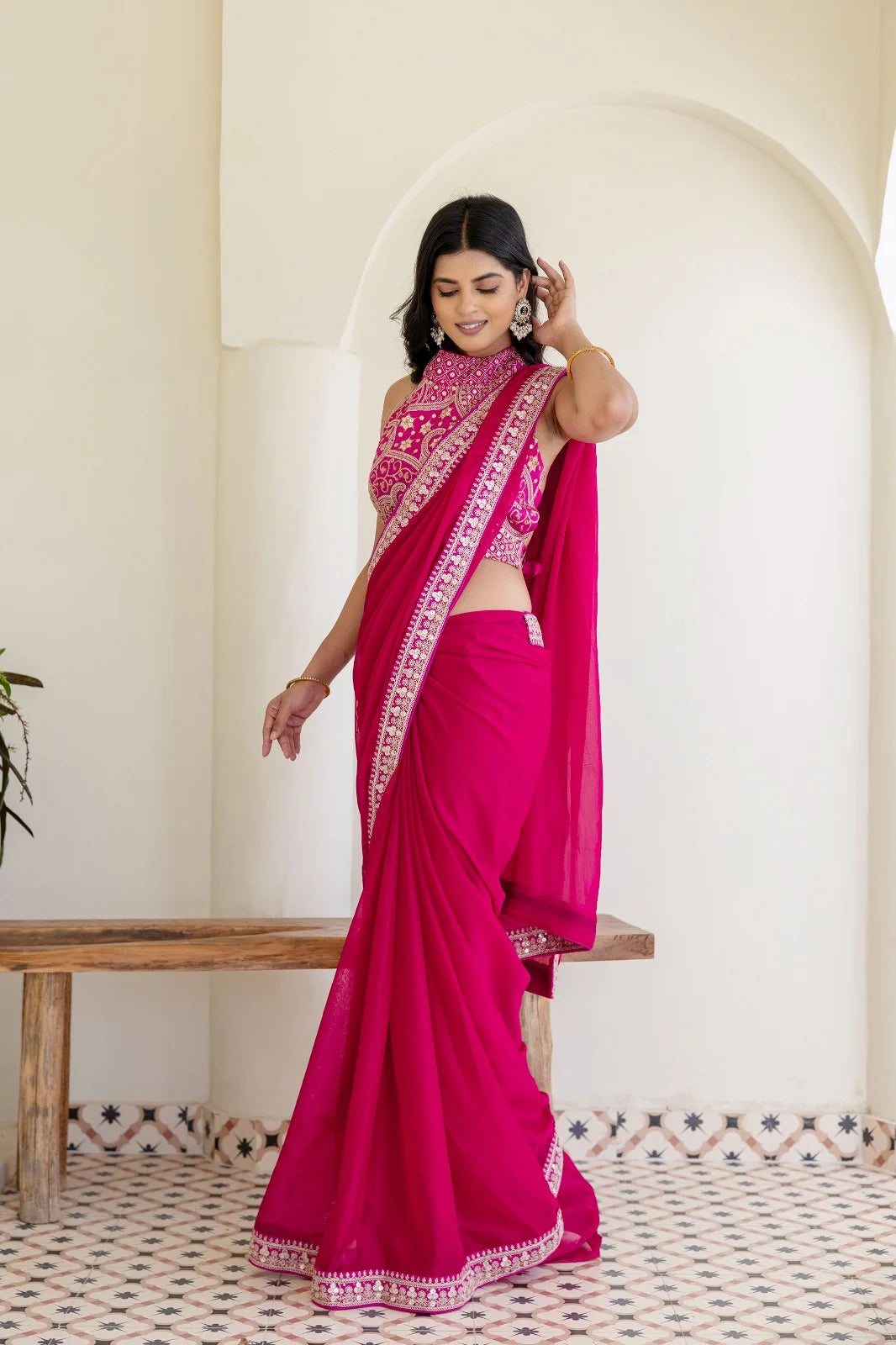 Rani pink ethnic silk-look saree designed for wedding events and grand festive styling.