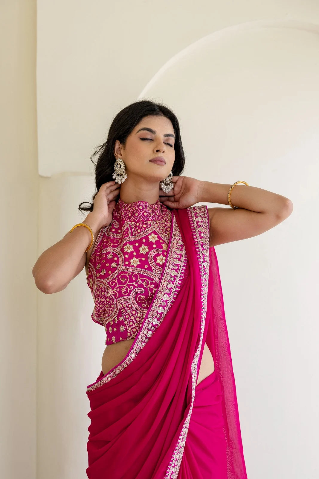 Rani pink partywear saree offering a stylish festive look ideal for functions and celebrations.
