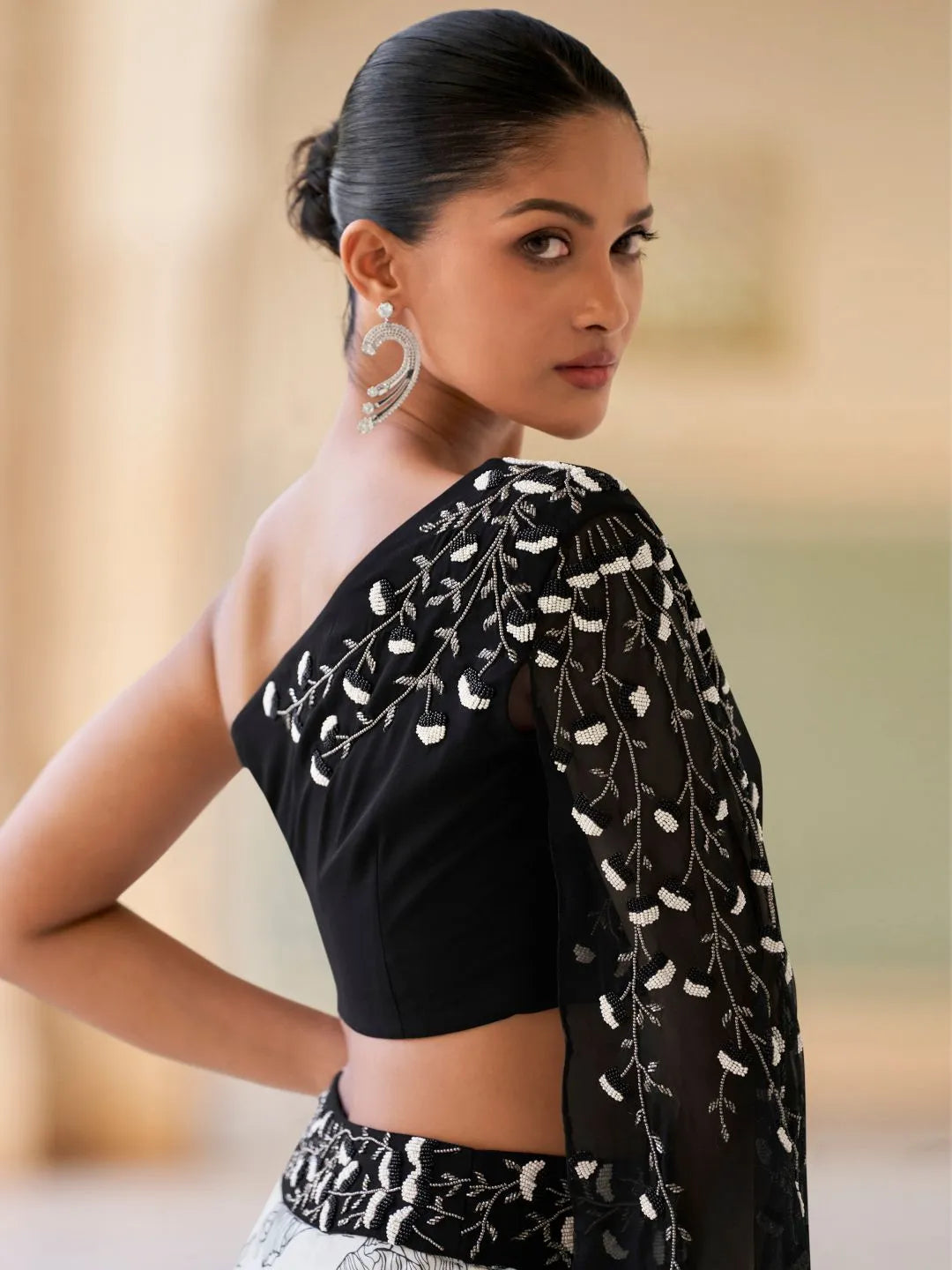 Black embroidery evening lehenga by Fulari with statement one shoulder design