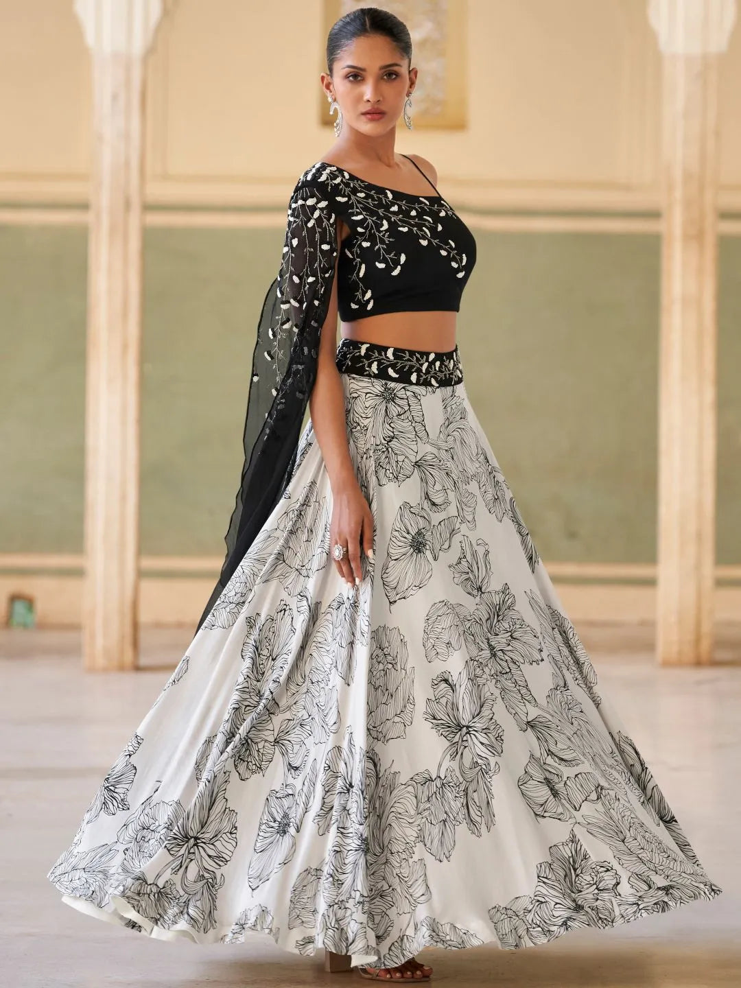 Black one shoulder embellished lehenga by Fulari with elegant floral skirt