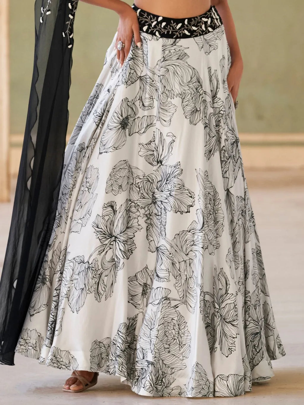 Black and white floral lehenga set by Fulari with one shoulder blouse