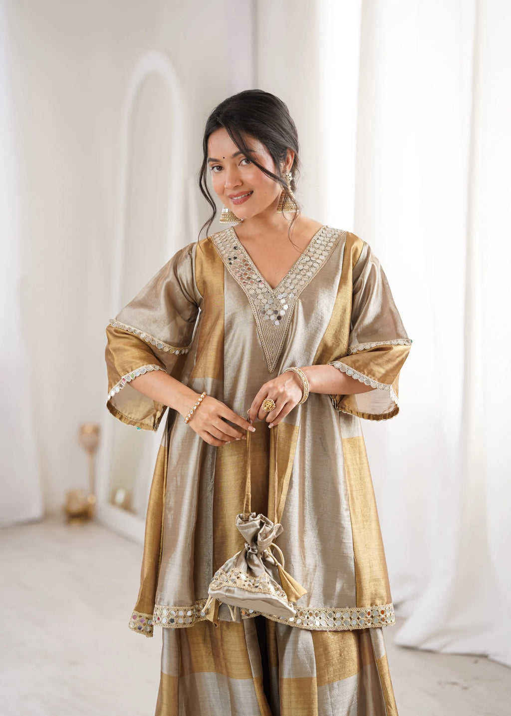 Gold wedding palazzo set by Fulari with mirror detailing and matching potli bag