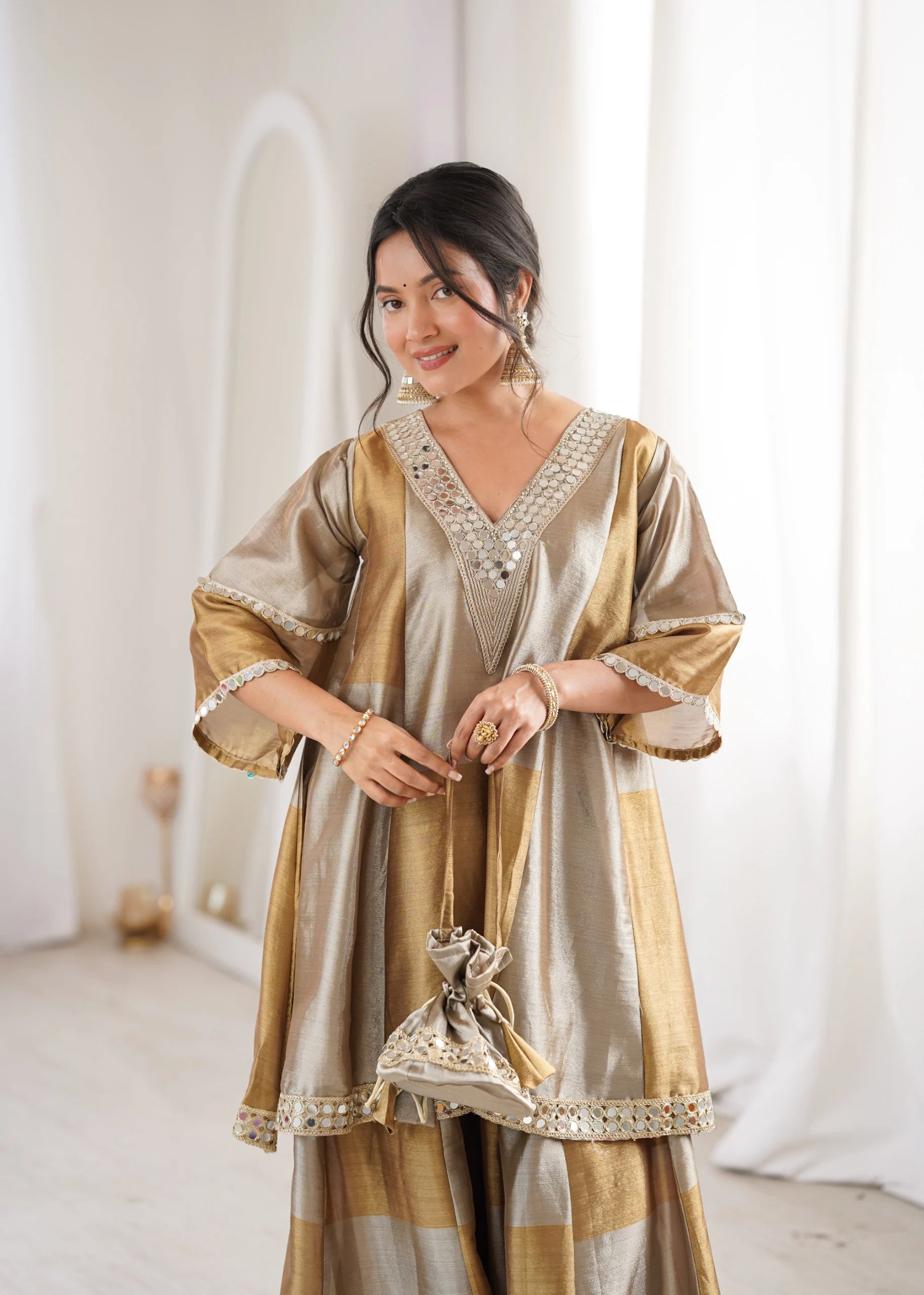 Gold wedding palazzo set by Fulari with mirror detailing and matching potli bag