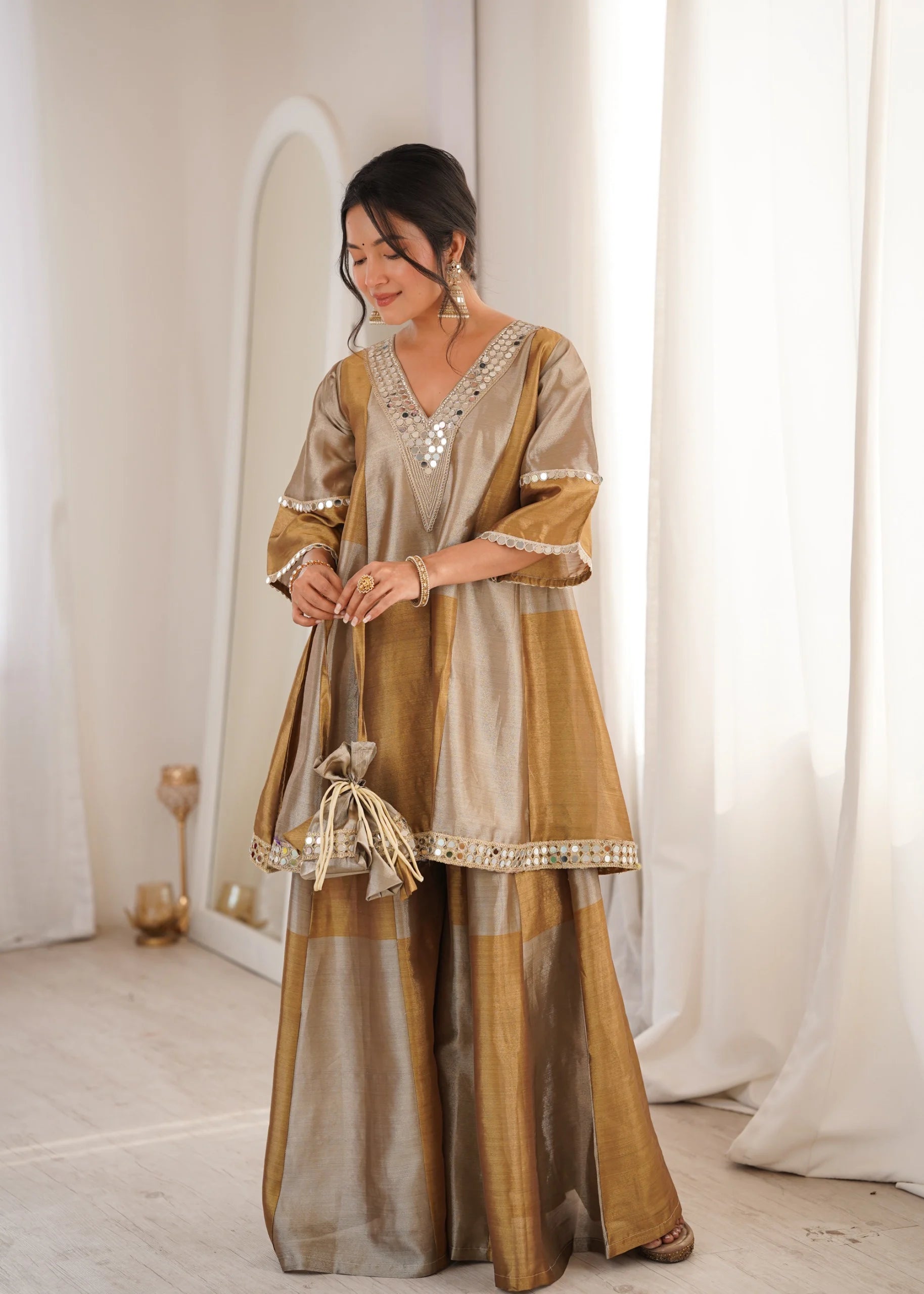 Golden mirror work tissue palazzo suit by Fulari with elegant festive design and flared silhouette