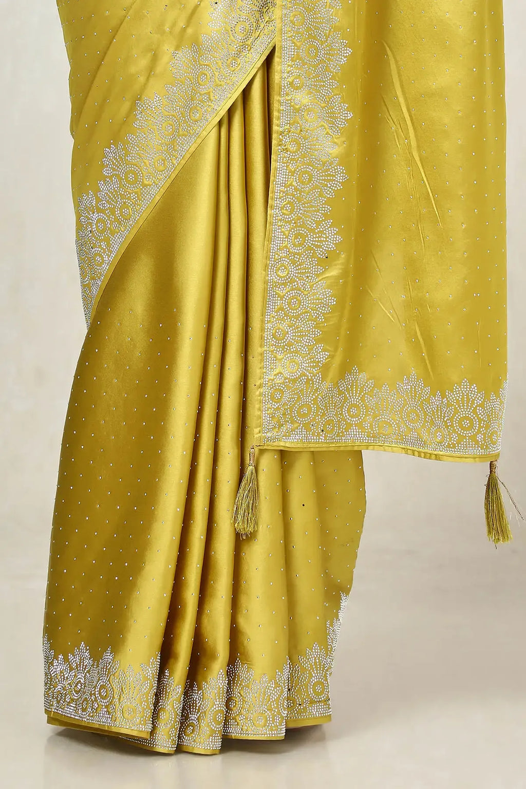 Mustard embellished satin saree with stone work by Fulari for festive and party wear