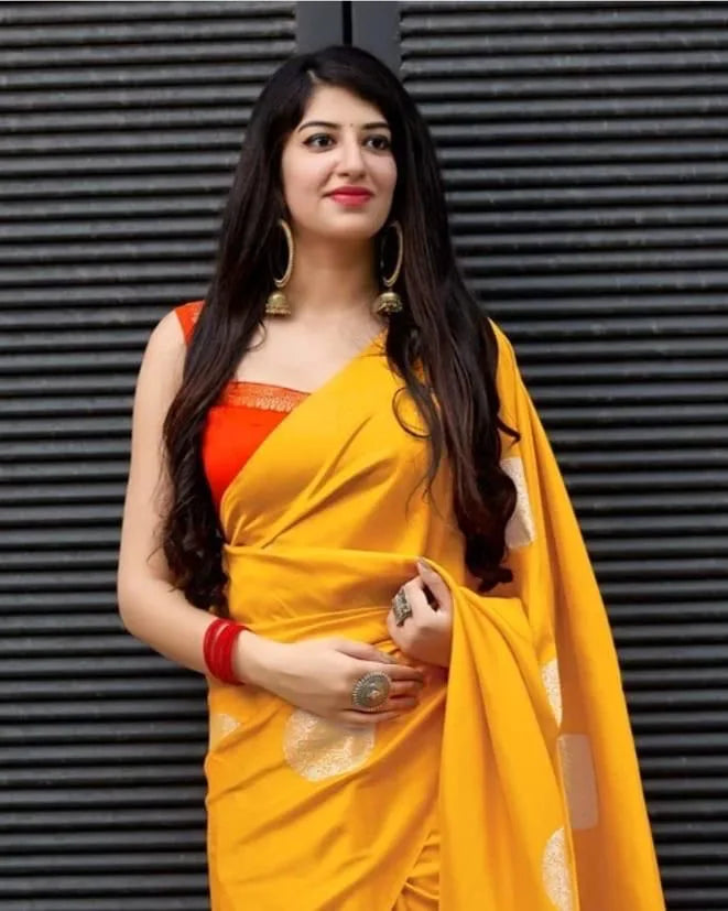 Woman wearing a yellow saree with an orange blouse