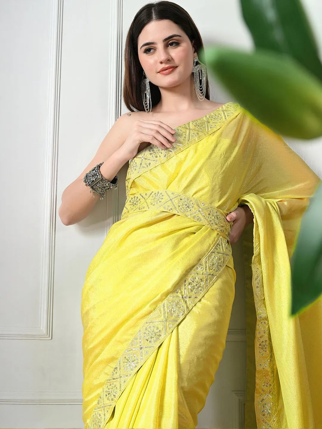Yellow designer chiffon saree by Fulari with detailed embroidered border