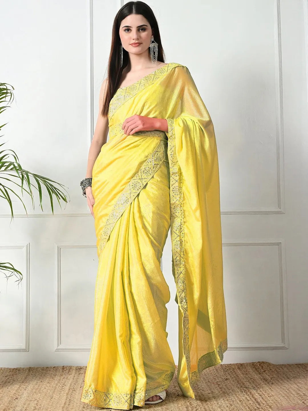 Yellow pure chiffon sequinned saree by Fulari with elegant embellished border