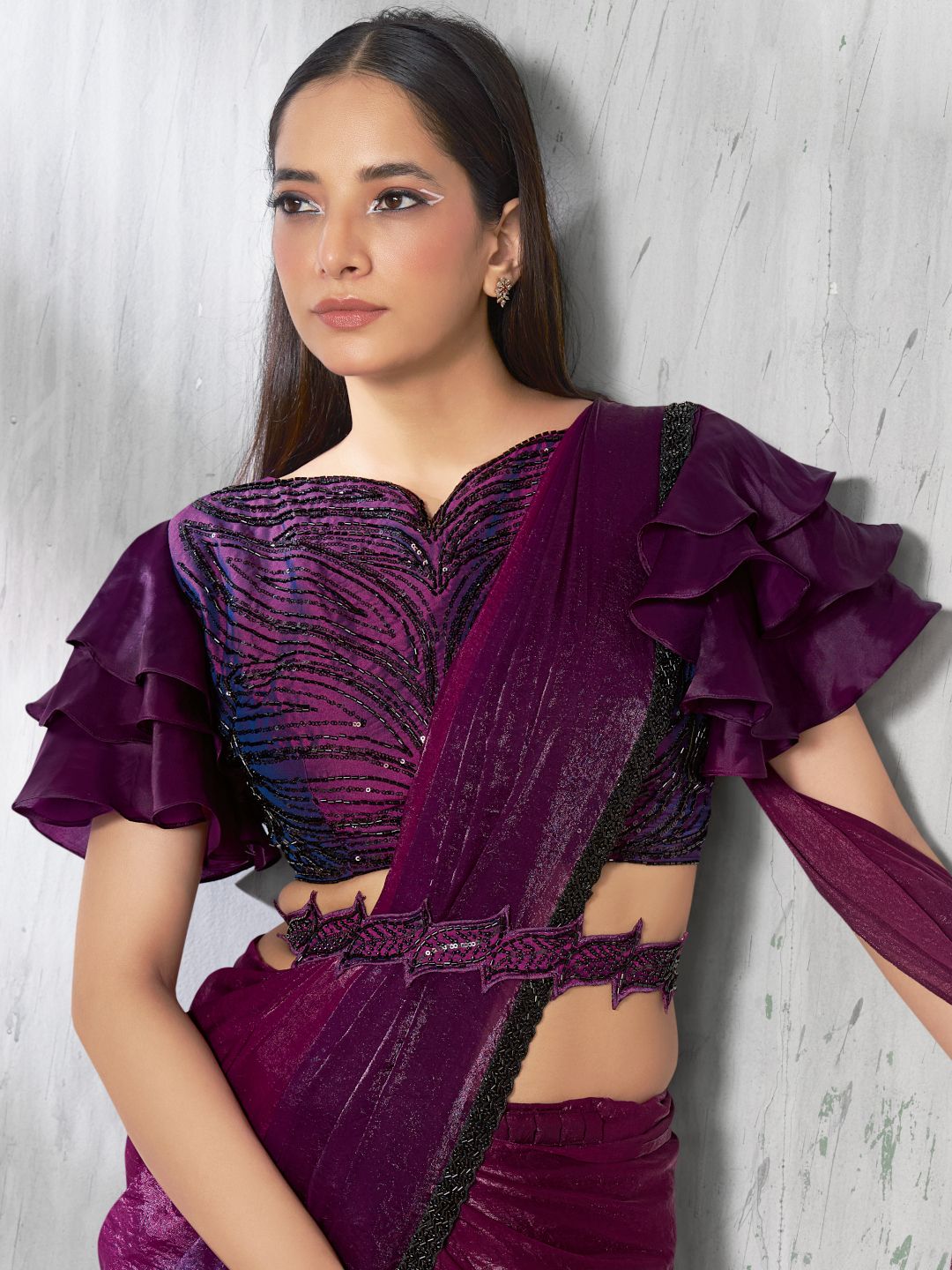 Woman wearing a purple saree with fulari